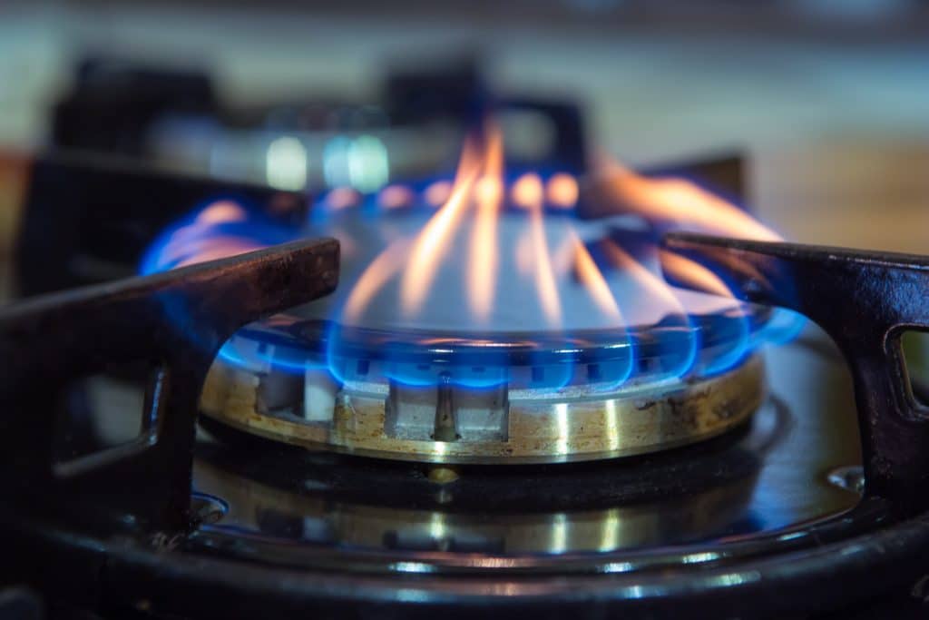 Blue flames on gas stove burner